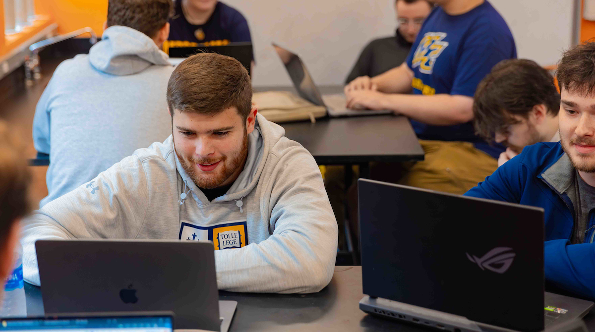 Photo of a group of students studying on laptops.