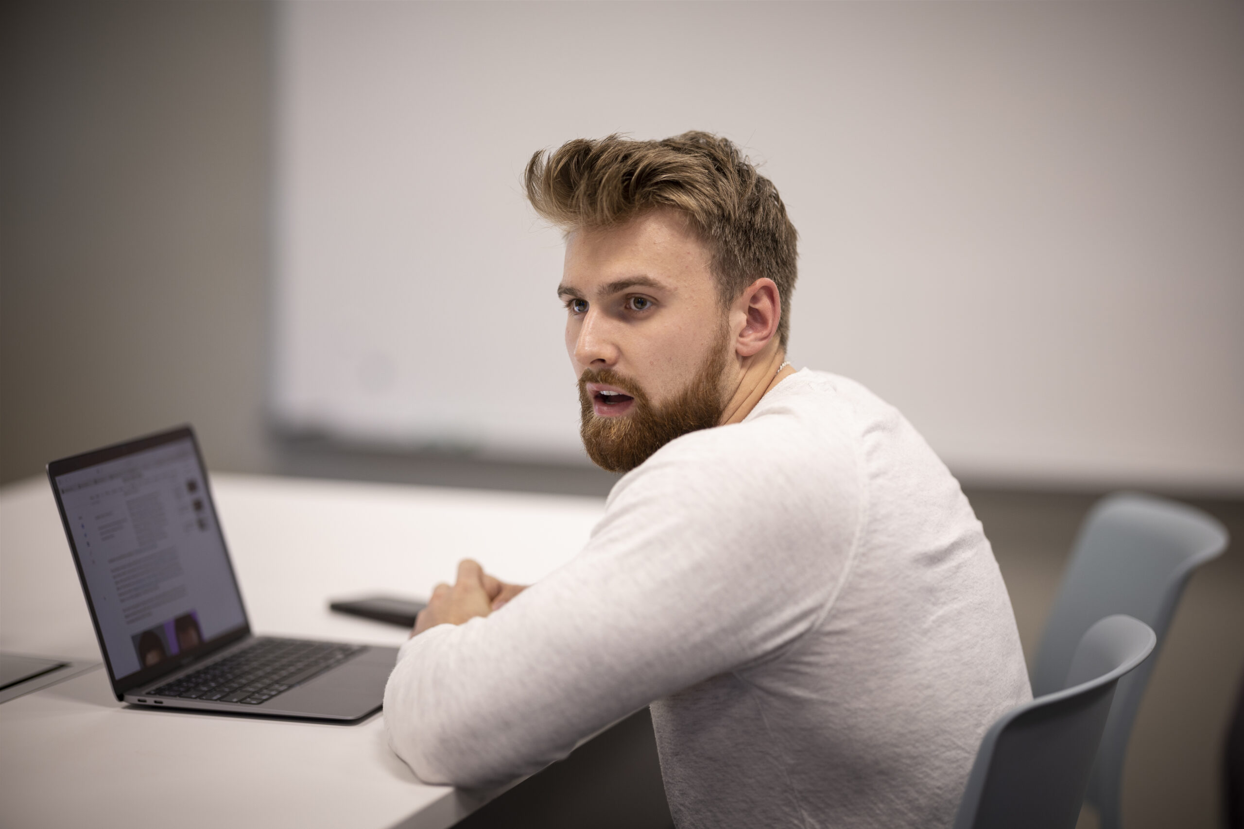 Male student speaking in business class