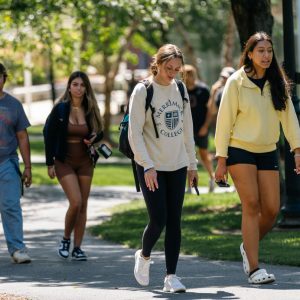 Outdoor students walking near grass